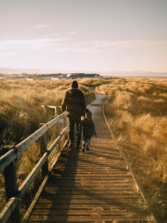 Father with Small Child Walking on the Boardwalk